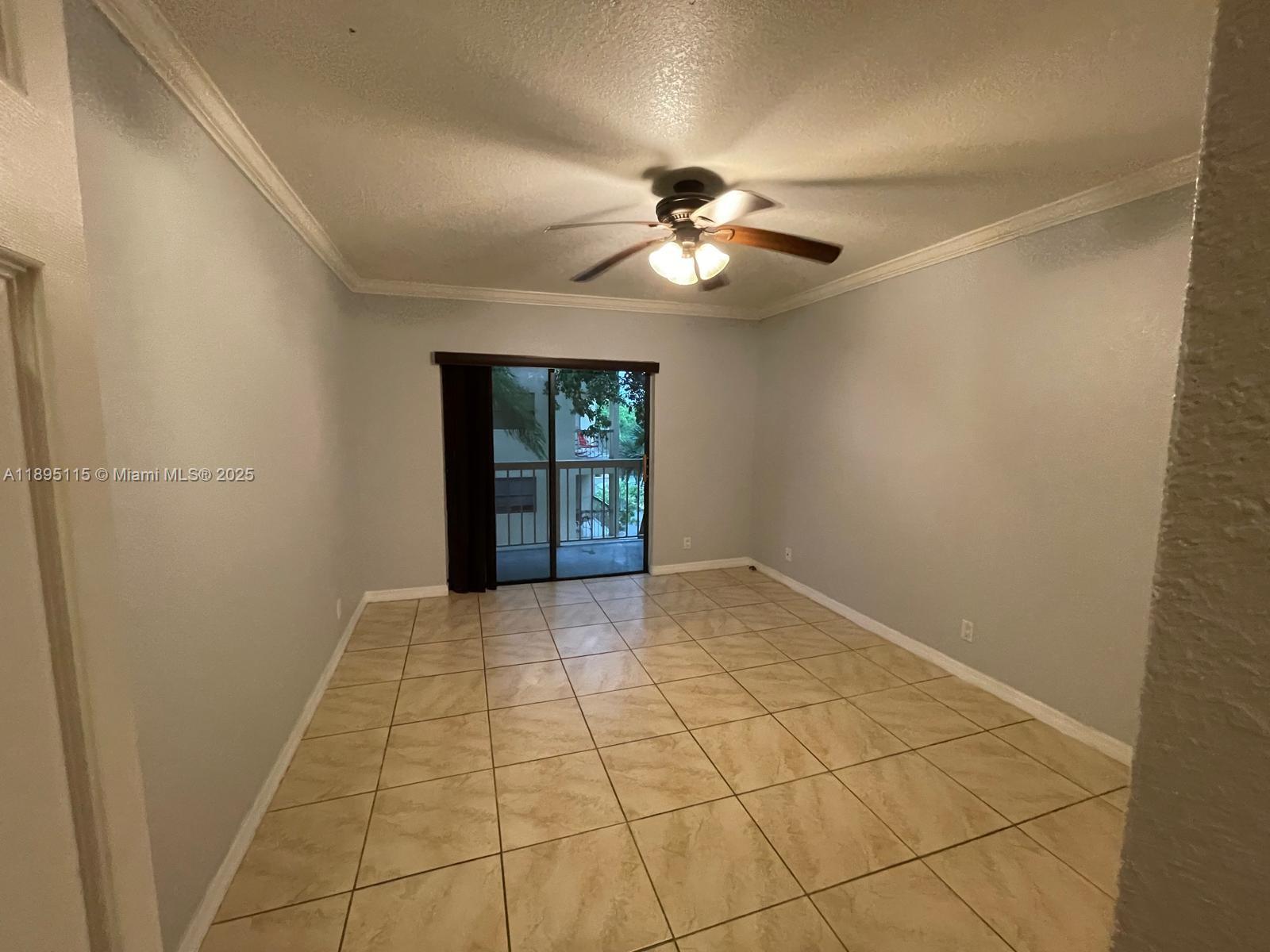 8100 Geneva Court, Unit 440 Doral, FL 33166 - Photo 9 of 11 a view of an empty room with a chandelier fan