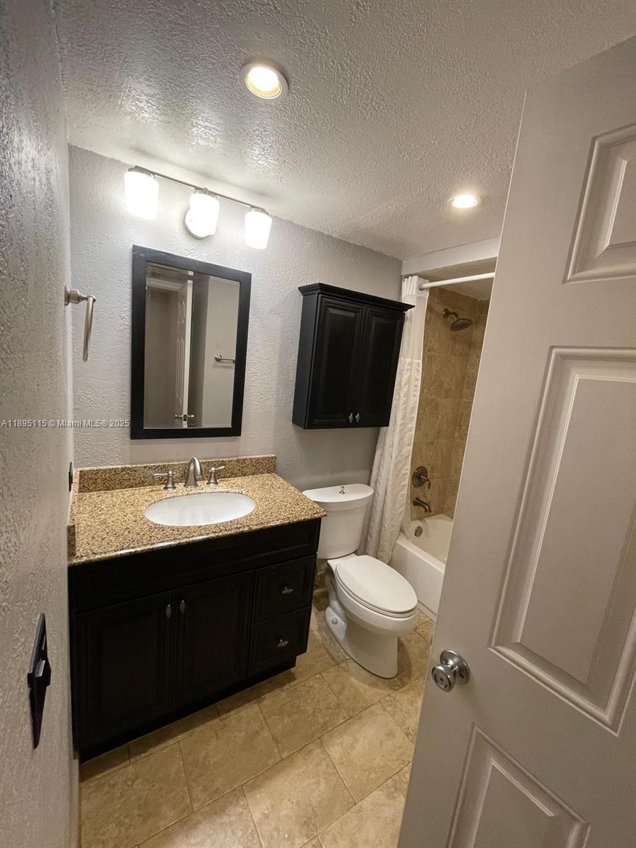 8100 Geneva Court, Unit 440 Doral, FL 33166 - Photo 10 of 11 a bathroom with a sink vanity mirror and toilet
