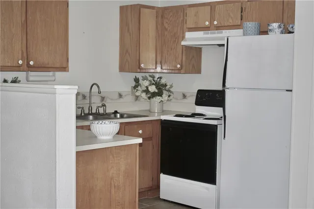 a kitchen with stainless steel appliances a sink and a refrigerator