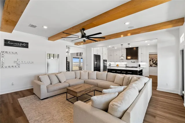 a living room with furniture and kitchen view