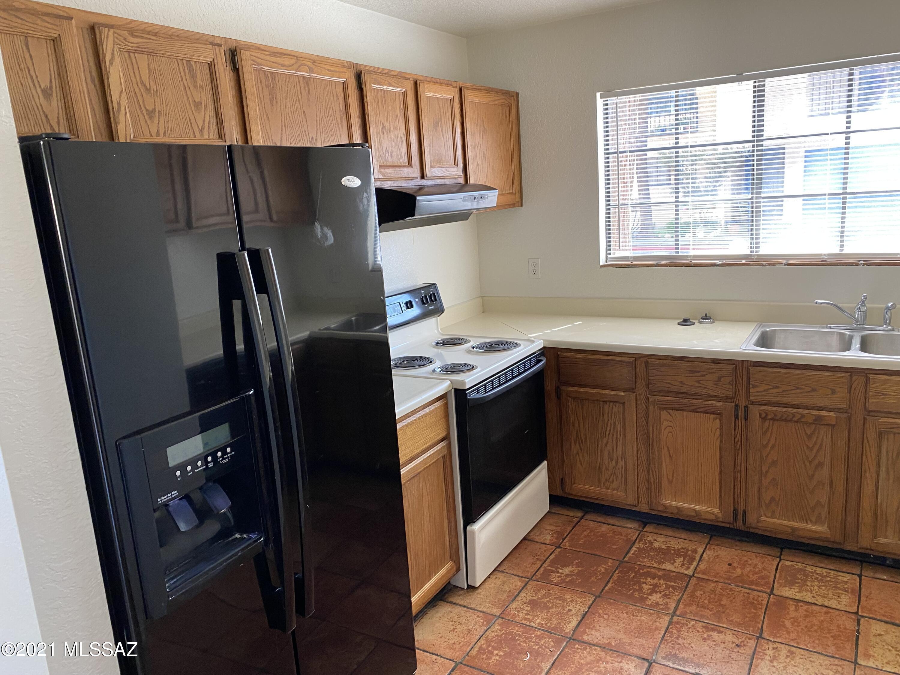 210 East Pastime Road Tucson, AZ 85705 - Photo 13 of 29 a kitchen with stainless steel appliances granite countertop a refrigerator stove and sink