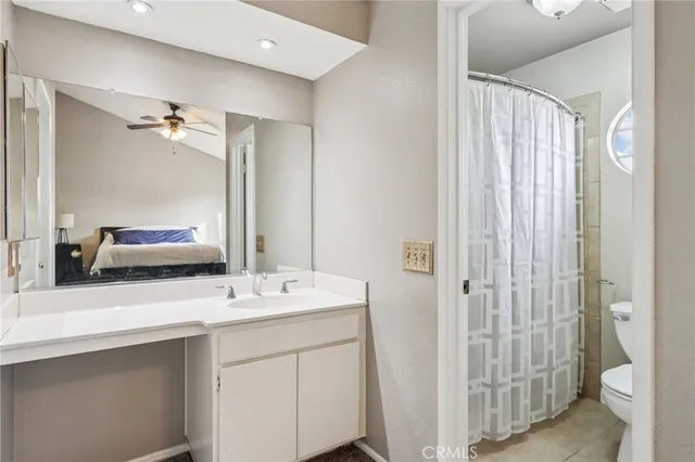 a bathroom with a double vanity sink toilet and shower