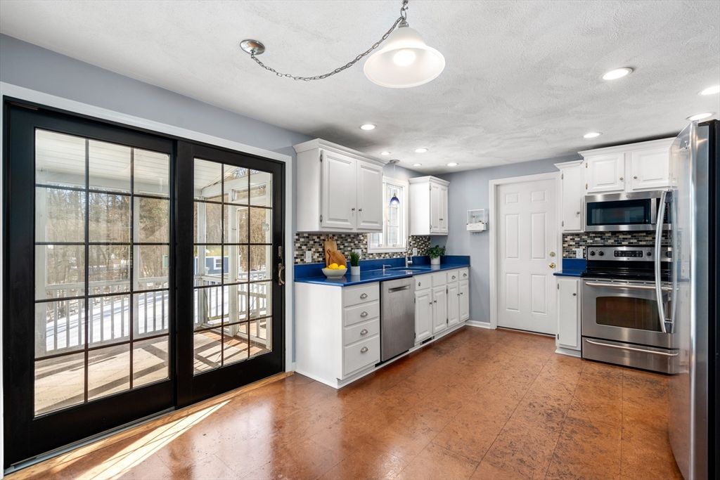 370 Peakham Road Sudbury, MA 01776 - Photo 18 of 41 a kitchen with stainless steel appliances a refrigerator sink and cabinets