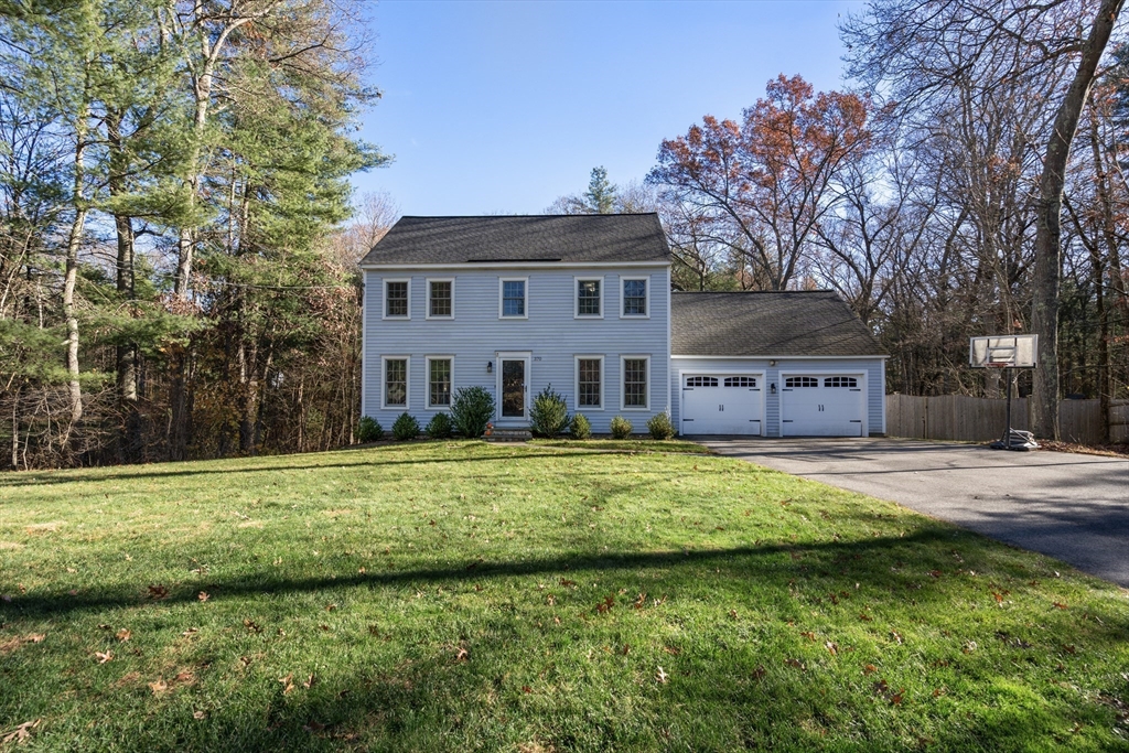 370 Peakham Road Sudbury, MA 01776 - Photo 2 of 41 a view of a house with a big yard and large trees