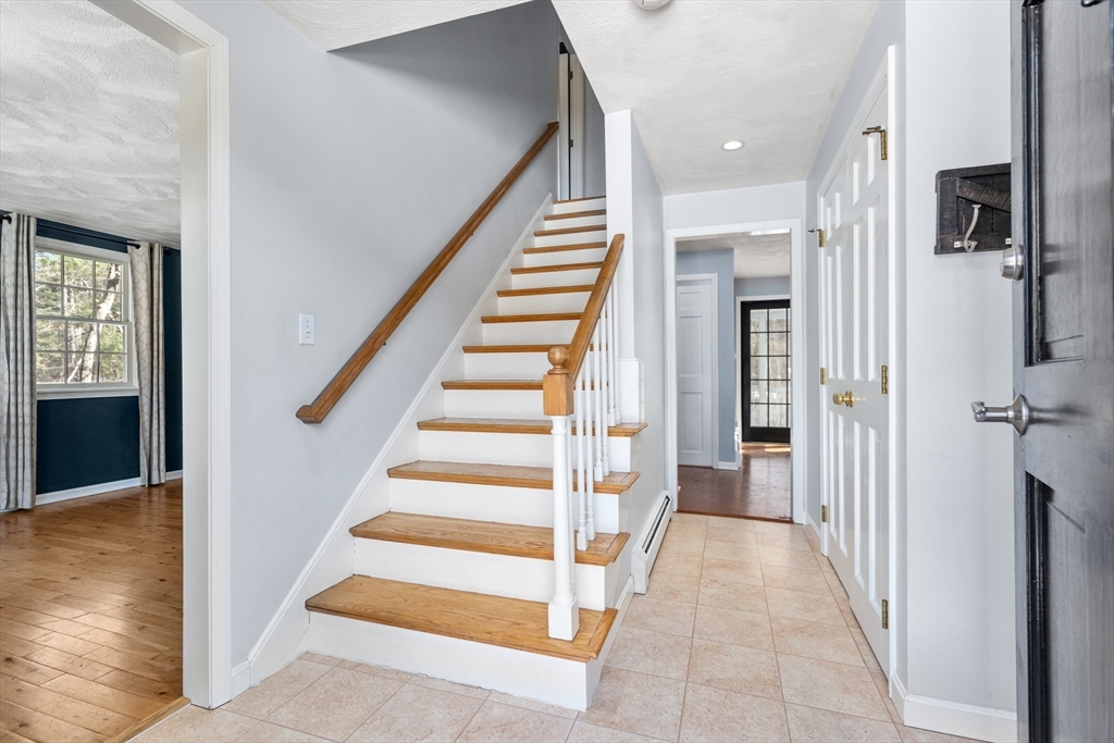 370 Peakham Road Sudbury, MA 01776 - Photo 22 of 41 a view of a hallway with wooden floor and staircase