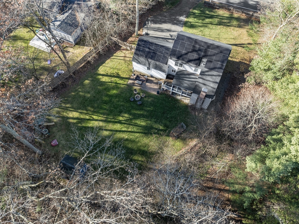 370 Peakham Road Sudbury, MA 01776 - Photo 34 of 41 a backyard of a house with a yard and large tree
