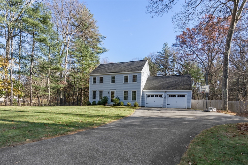 370 Peakham Road Sudbury, MA 01776 - Photo 38 of 41 a view of a white house with a big yard and large trees