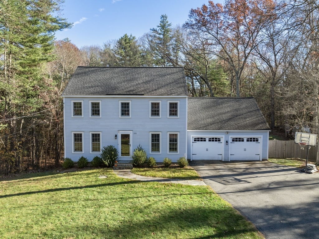370 Peakham Road Sudbury, MA 01776 - Photo 6 of 41 a front view of a house with a yard