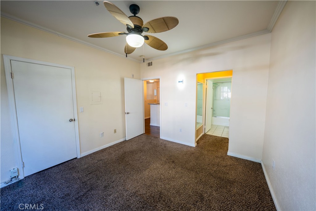 640 West 4th Street, Unit 101 Long Beach, CA 90802 - Photo 16 of 25 an empty room with a chandelier fan and closet