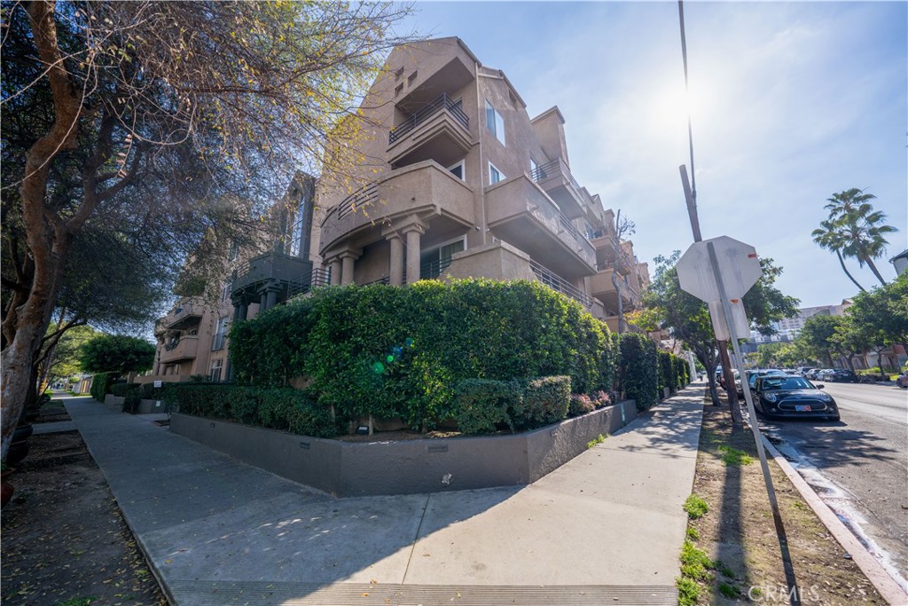 640 West 4th Street, Unit 101 Long Beach, CA 90802 - Photo 2 of 25 a view of a building with a garden and pathway