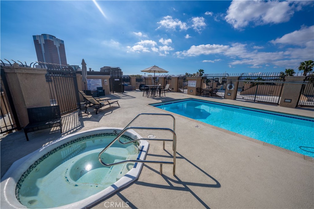 640 West 4th Street, Unit 101 Long Beach, CA 90802 - Photo 22 of 25 a view of a swimming pool with chair and table