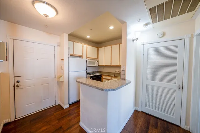 a view of a kitchen with a fridge and dishwasher