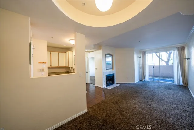 a large kitchen with stainless steel appliances a large counter top a stove and a refrigerator