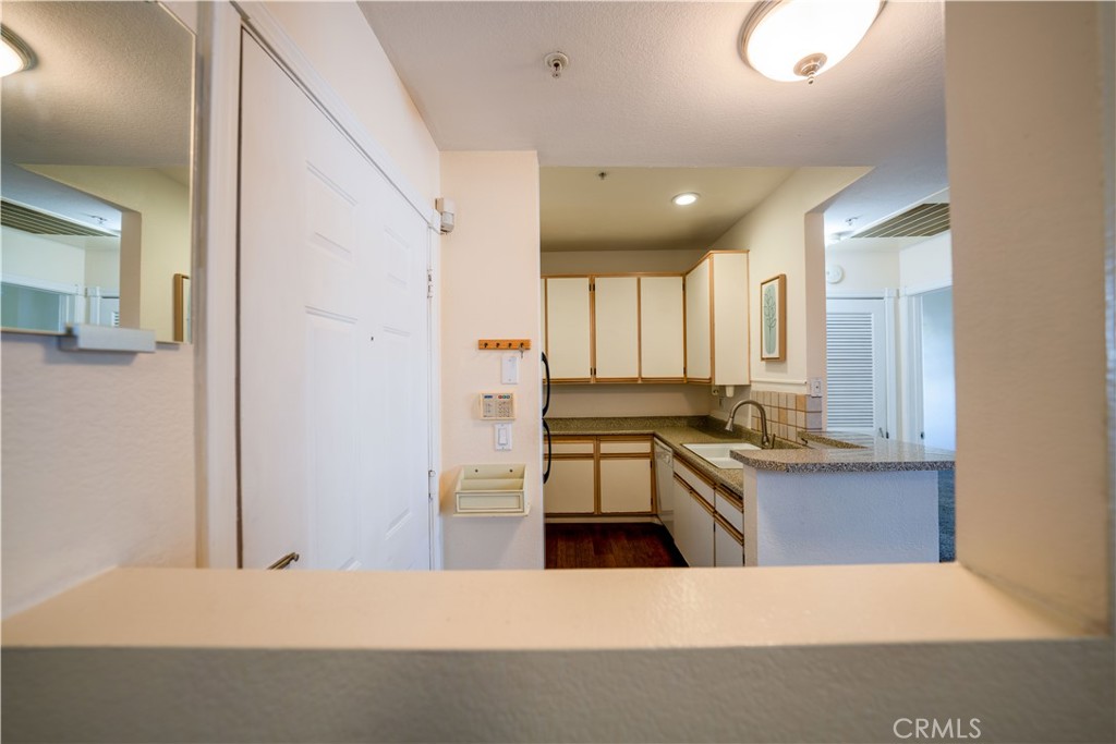 640 West 4th Street, Unit 101 Long Beach, CA 90802 - Photo 10 of 25 a large kitchen with stainless steel appliances a large counter top a stove and a refrigerator