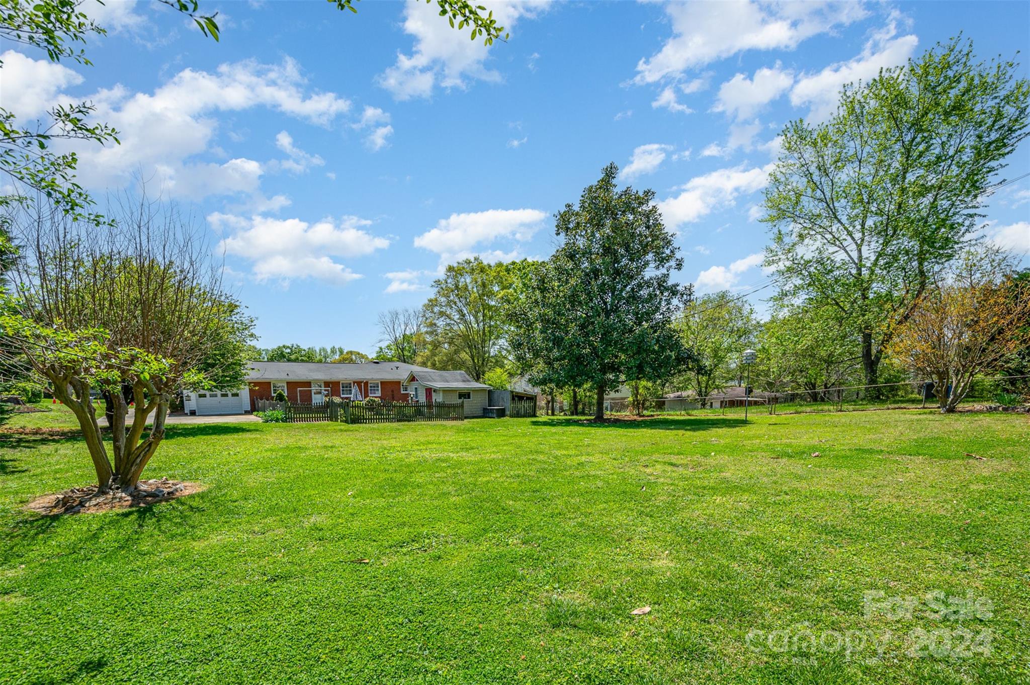 3409 Oak Tree Trail Matthews, NC 28105 - Photo 26 of 26 a view of a big yard with a plants and trees