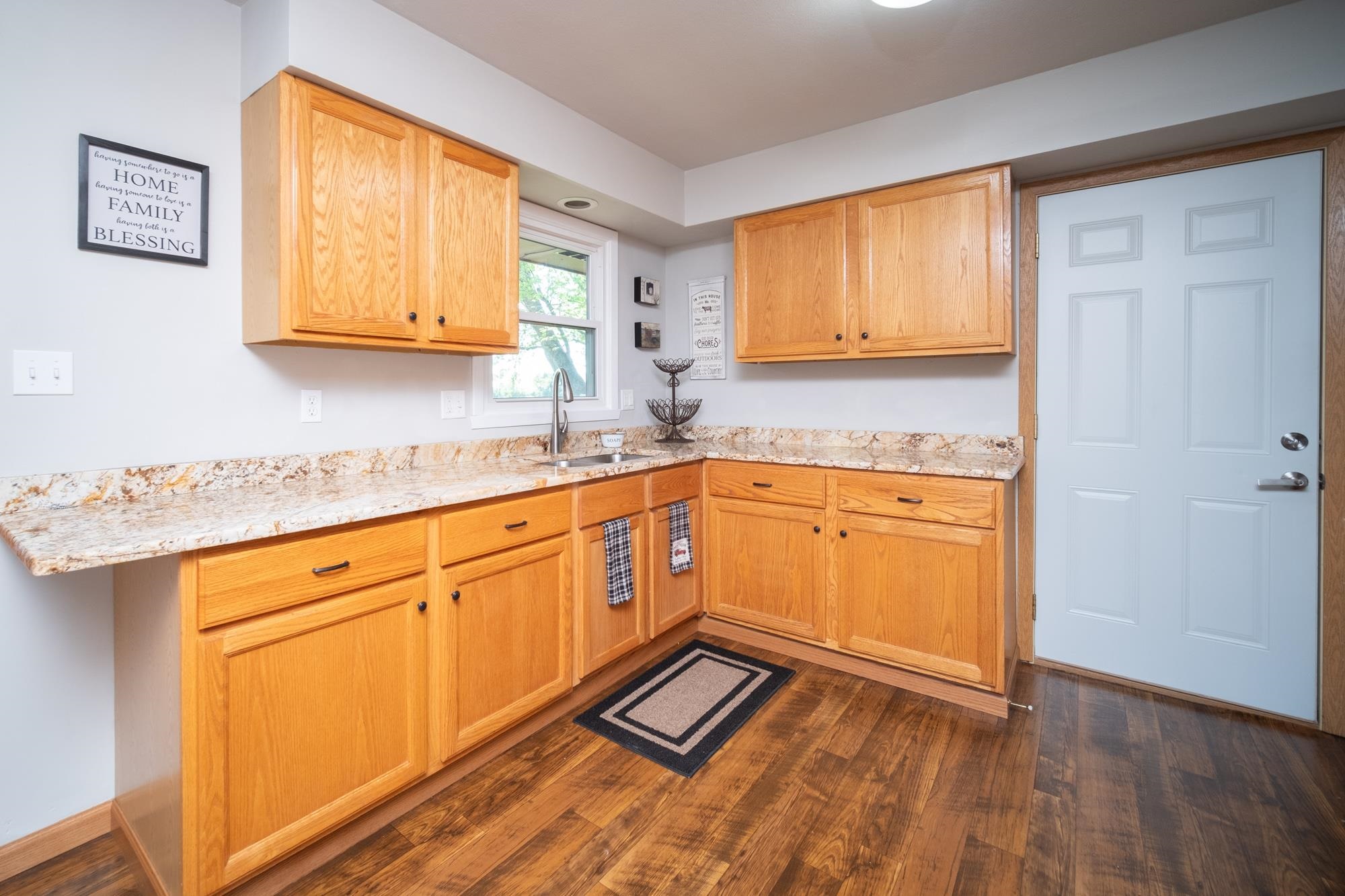 10030 Cemetery Road Pecatonica, IL 61063 - Photo 12 of 39 a kitchen with stainless steel appliances granite countertop a sink cabinets and wooden floor