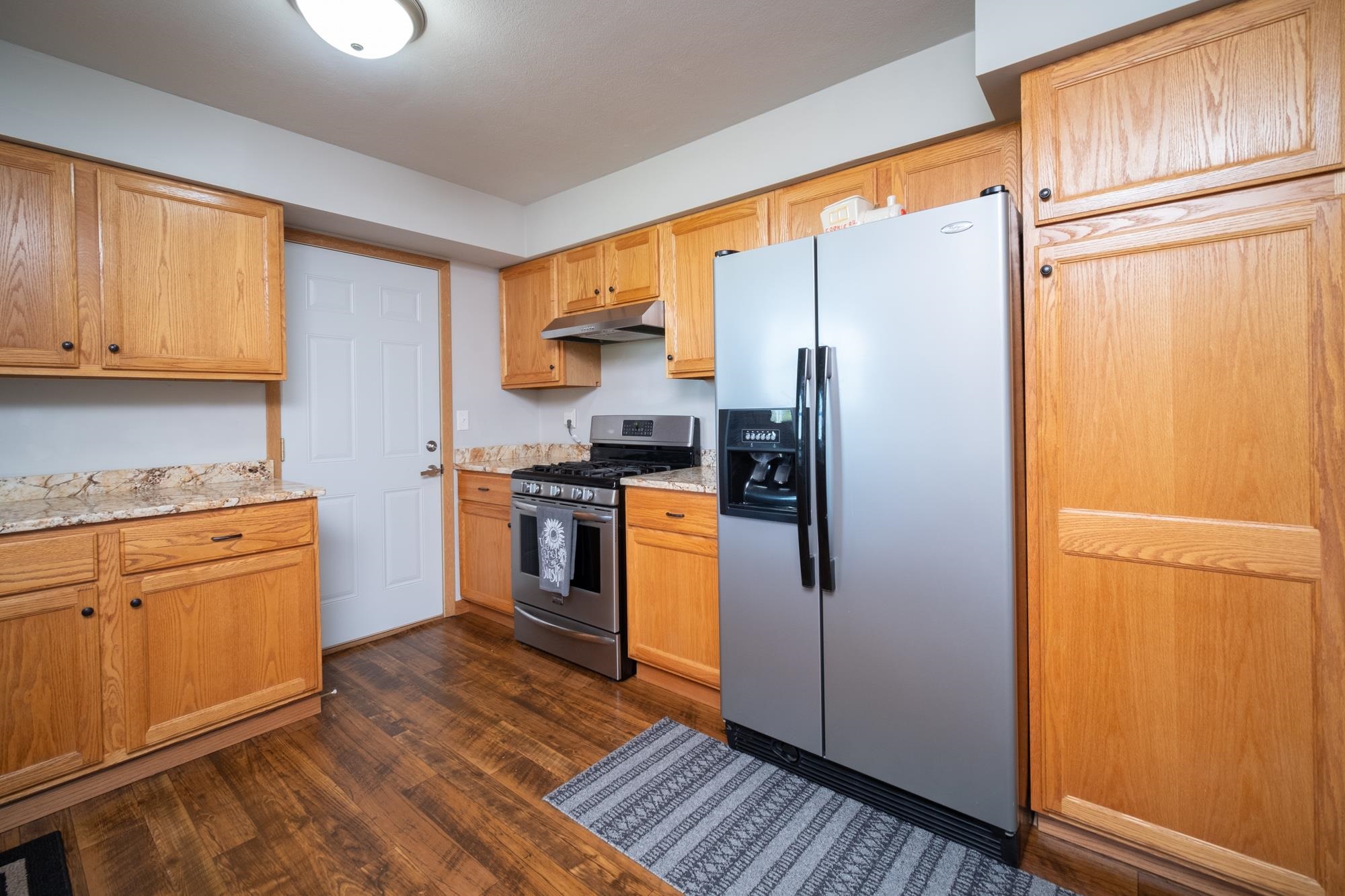 10030 Cemetery Road Pecatonica, IL 61063 - Photo 13 of 39 a kitchen with stainless steel appliances granite countertop a refrigerator and a stove top oven