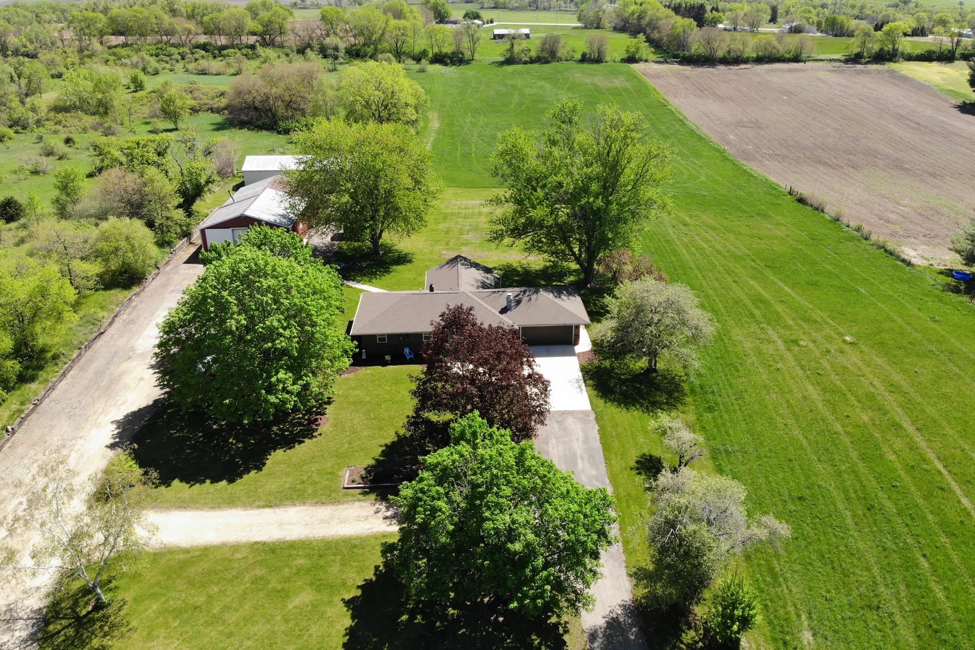 10030 Cemetery Road Pecatonica, IL 61063 - Photo 4 of 39 an aerial view of green landscape with trees houses and mountain view