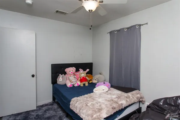 a bedroom with a bed and a dresser