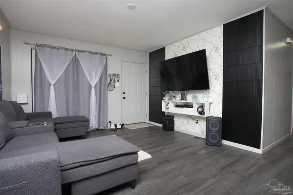 a living room with furniture and a flat screen tv