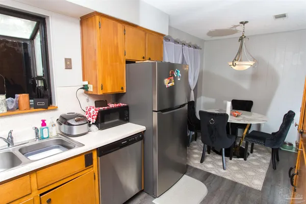 a kitchen with a refrigerator and a sink