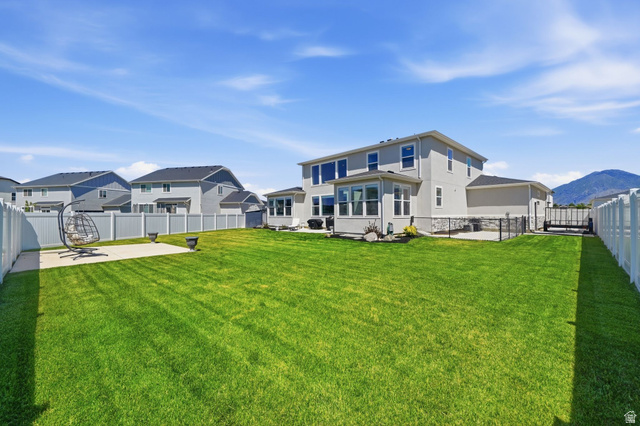 1165 West Union Bench Drive Mapleton, UT 84664 - Photo 56 of 61 Expansive green lawn with a white vinyl privacy fence bordering the property