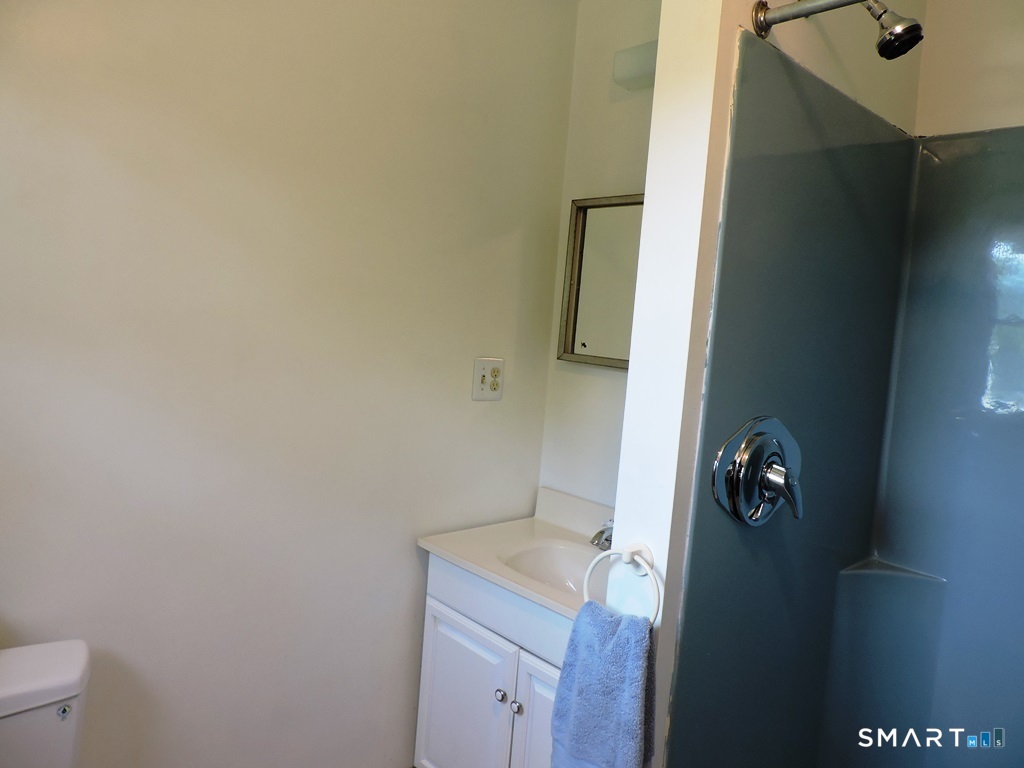 269 Griffin Road South Windsor, CT 06074 - Photo 17 of 36 a bathroom with a granite countertop toilet and sink