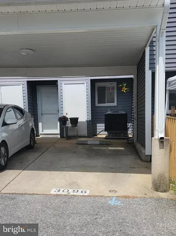 a view of living room filled with furniture and a fireplace