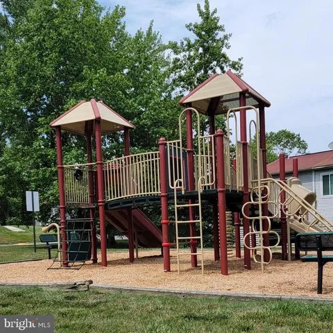 an outdoor space with lots of swings and slides