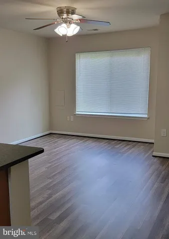 a view of a room with wooden floor and fan