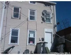 a view of a house with a door and a yard
