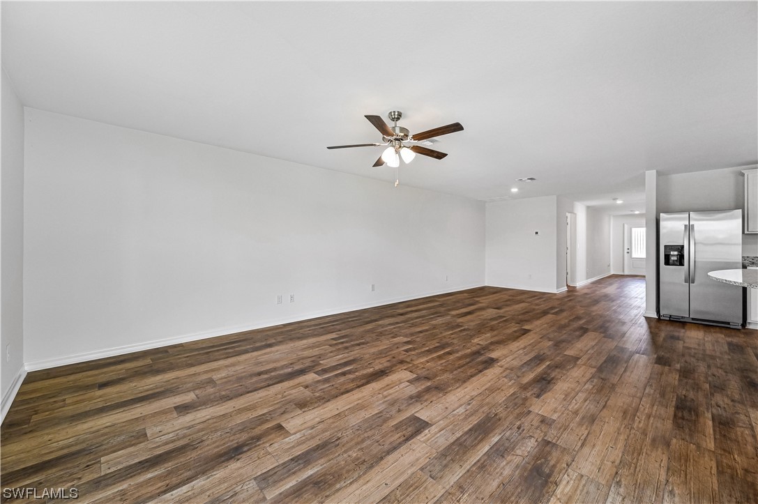 1344 Lincoln Court Immokalee, FL 34142 - Photo 6 of 21 a view of a livingroom with a hardwood floor and a ceiling fan