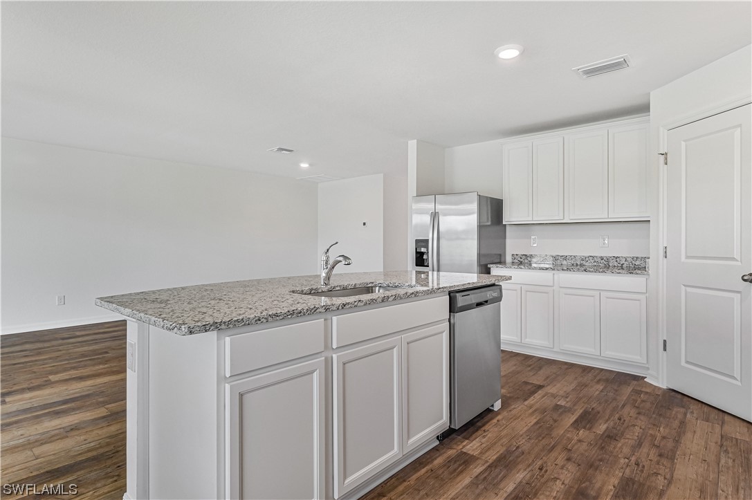 1344 Lincoln Court Immokalee, FL 34142 - Photo 9 of 21 a kitchen with a sink stove and cabinets
