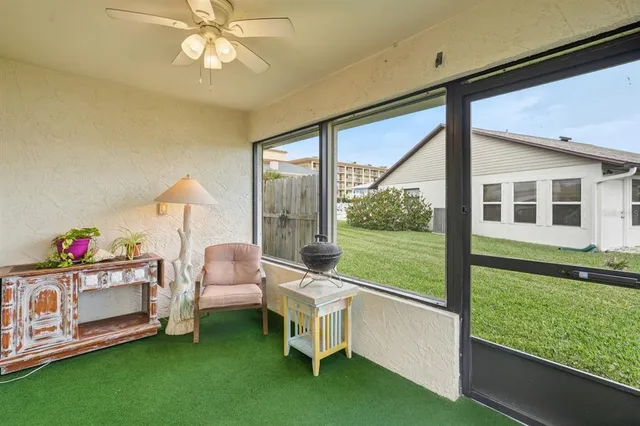 a living room with a floor to ceiling window and pool