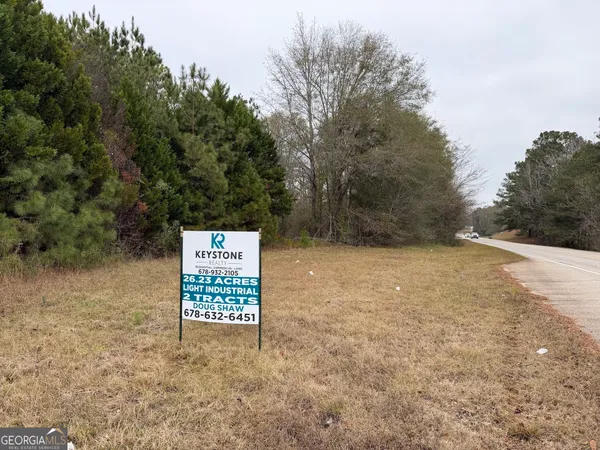a view of a house with pool and sitting area