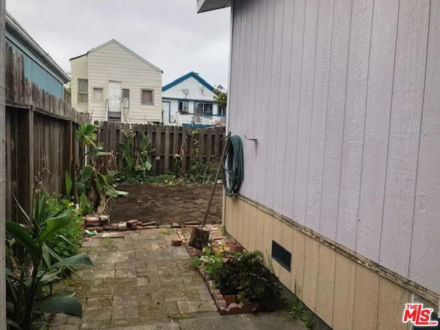a view of a house with wooden fence