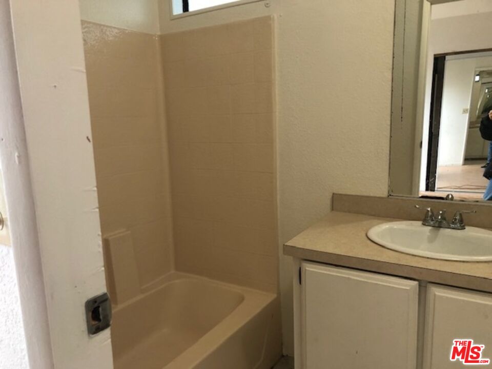 355 Center Street Oakland, CA 94607 - Photo 8 of 10 a bathroom with a sink and a mirror