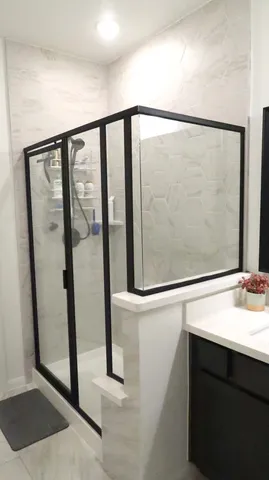 a bathroom with a shower and a mirror