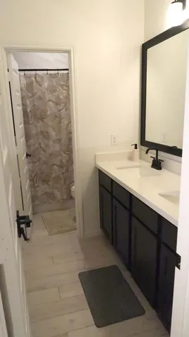 a bathroom with a sink a mirror and shower