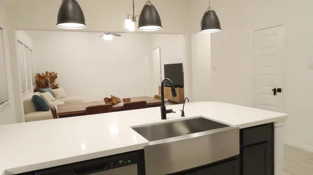 a living room with a sink and a chandelier