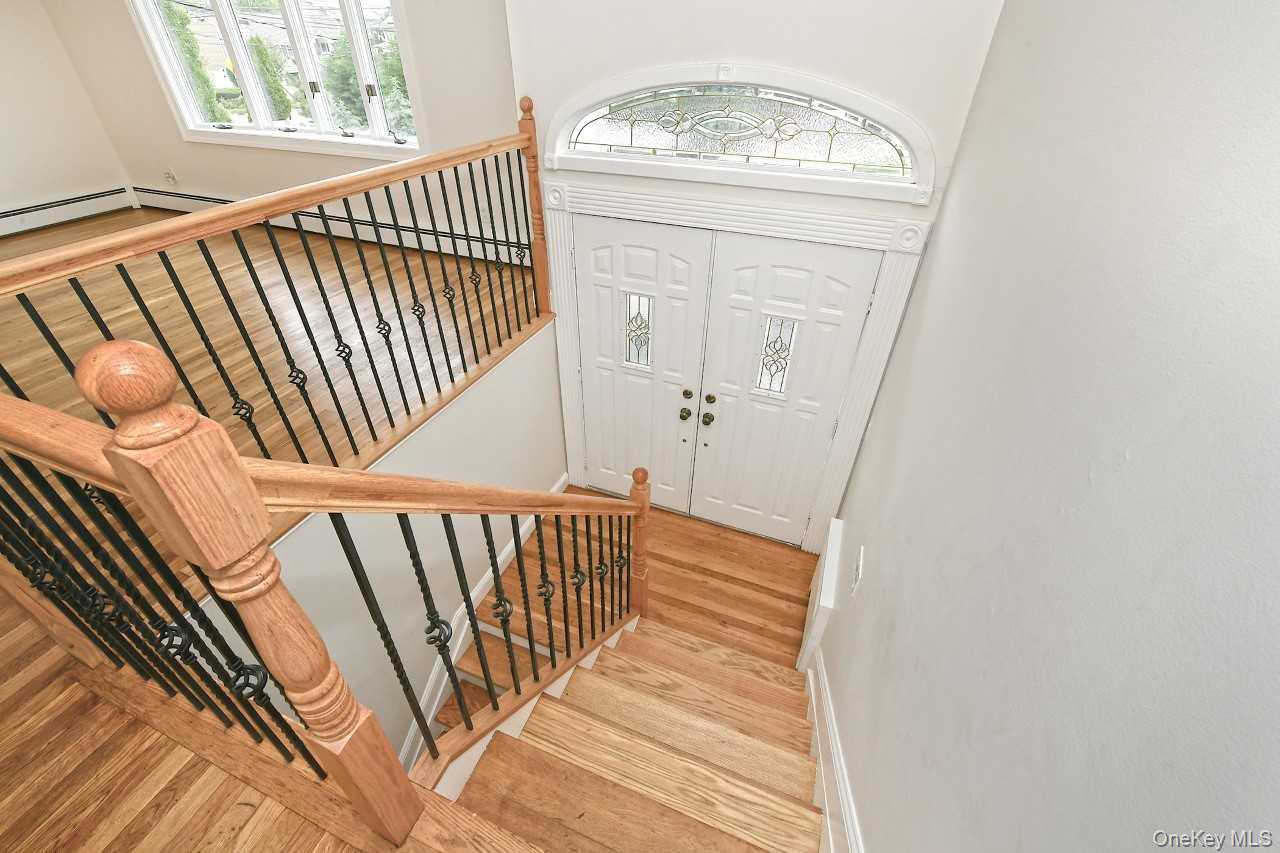 107 Beverly Road Massapequa, NY 11758 - Photo 4 of 41 a view of stairs with wooden floor