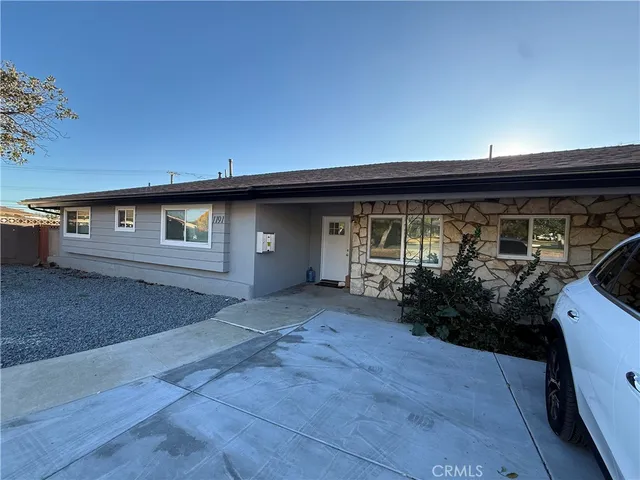 a view of backyard with potted plants and wooden fence