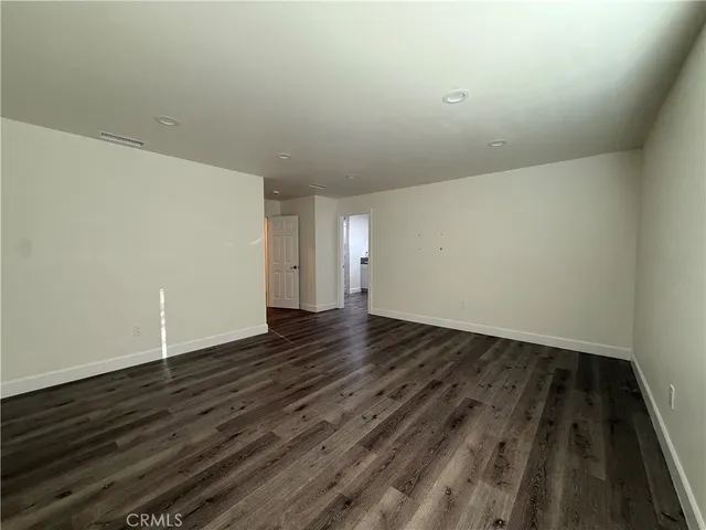 a view of an empty room and wooden floor