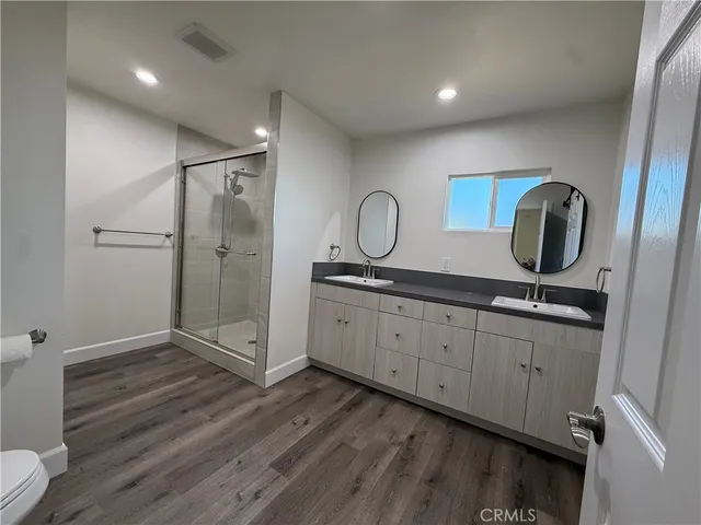 a bathroom with a double vanity sink and mirror