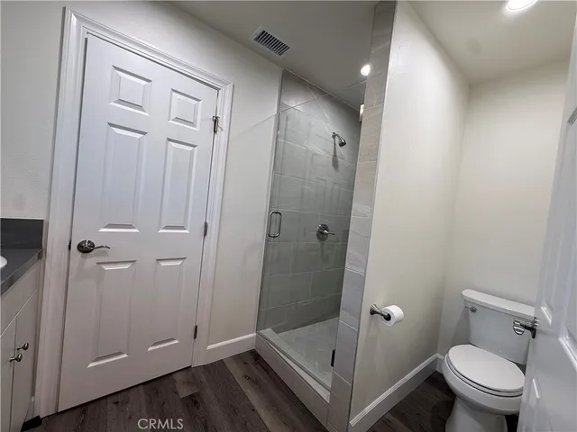 a bathroom with a shower and toilet