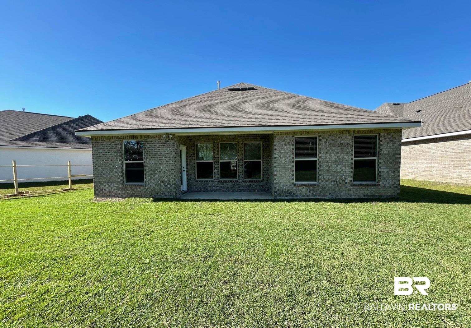 1428 Fenton Circle Foley, AL 36535 - Photo 13 of 15 Rear view of property with a yard