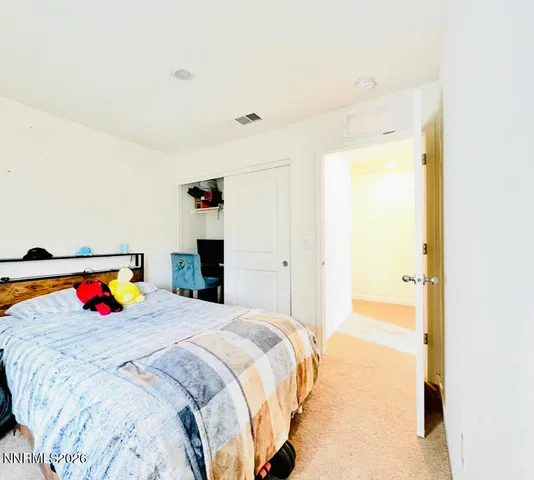 a bedroom with a bed and a painting on the wall