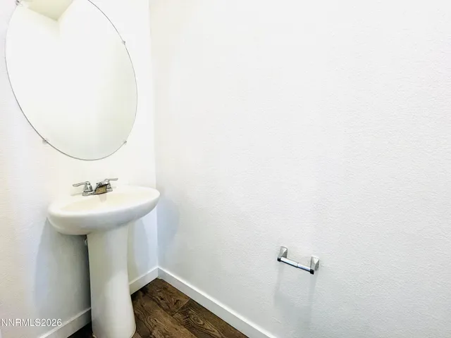 a bathroom with a sink a mirror and toilet