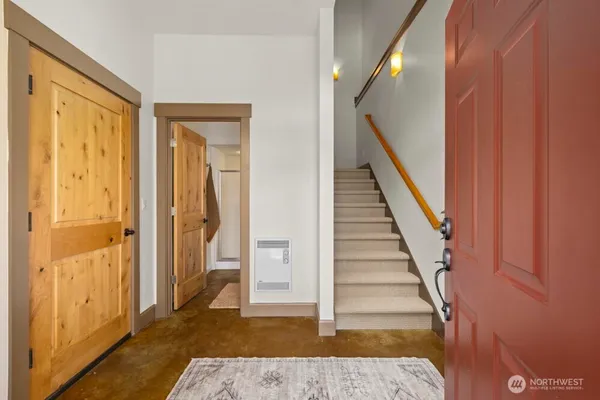 a view of a hallway with wooden floor and entryway