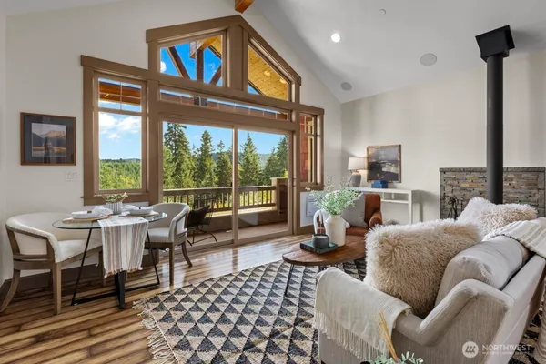 a living room with furniture and a floor to ceiling window